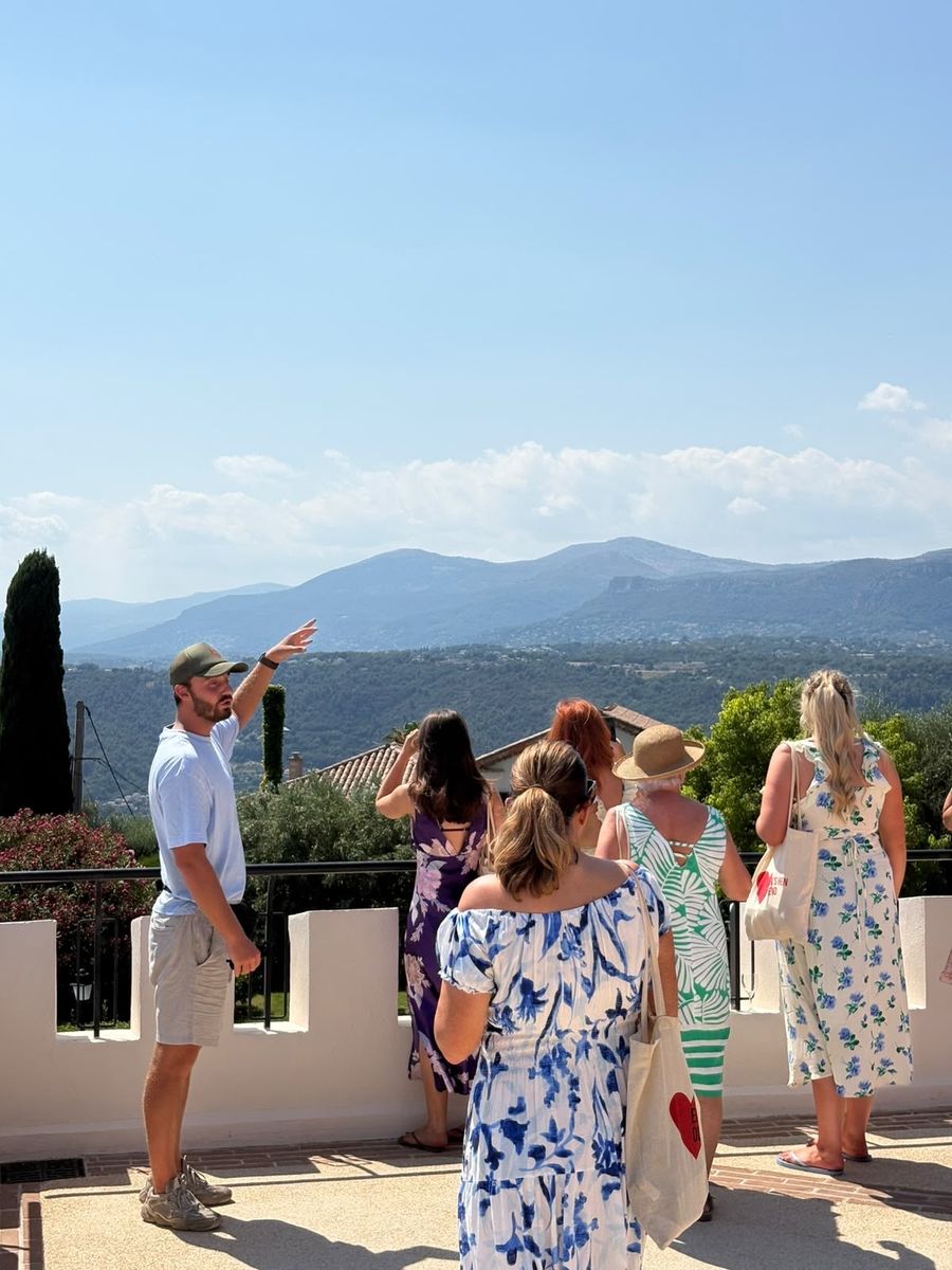 Le guide montre le panorama sur les collines depuis la terrasse du Château